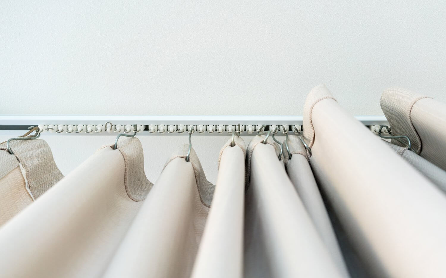 White curtain rail system with light brown curtain